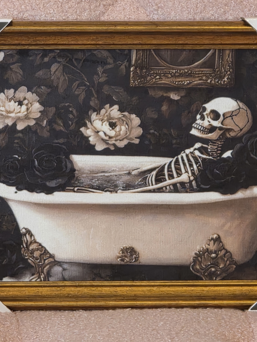Decorative framed wall art featuring a skeleton reclining in a bathtub